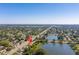 Stunning aerial view showcasing a house next to a serene lake within a lush, green community at 4322 22Nd N Ave, St Petersburg, FL 33713