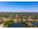 An aerial photo of a home beside a pond with mature trees in a lush, green neighborhood at 4322 22Nd N Ave, St Petersburg, FL 33713