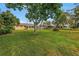 Large backyard with mature trees providing shade, a patio seating area, and a peaceful setting at 4322 22Nd N Ave, St Petersburg, FL 33713