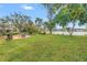 Expansive backyard with lush greenery, cozy patio seating, and serene lake views, perfect for relaxation and outdoor living at 4322 22Nd N Ave, St Petersburg, FL 33713