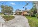 Inviting home exterior with a curved driveway, charming front porch, and colorful landscaping at 4322 22Nd N Ave, St Petersburg, FL 33713