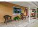 Inviting front porch with tiled floor, wicker chairs, and decorative white columns at 4322 22Nd N Ave, St Petersburg, FL 33713