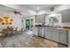 Updated kitchen with stainless steel appliances, light grey cabinets, and a dining area at 4322 22Nd N Ave, St Petersburg, FL 33713