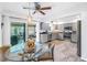 Open kitchen area with gray cabinets and stainless steel appliances, adjacent to a sunroom at 4322 22Nd N Ave, St Petersburg, FL 33713