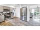 Modern kitchen with stainless steel appliances and wood-look tile floors at 4322 22Nd N Ave, St Petersburg, FL 33713