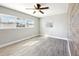 Bedroom featuring wood-look tile floors, ceiling fan, and windows at 4514 S Shamrock Rd, Tampa, FL 33611