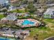 Picturesque aerial view of a sparkling community pool surrounded by tropical trees and cozy lounge chairs at 4966 Coquina Key Se Dr # 4966, St Petersburg, FL 33705