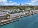 Elevated aerial captures waterfront condos along the coast, with the city skyline in the distance at 4966 Coquina Key Se Dr # 4966, St Petersburg, FL 33705