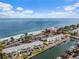 Stunning aerial view of waterfront condos, palm trees, and boats, creating a coastal living paradise at 4966 Coquina Key Se Dr # 4966, St Petersburg, FL 33705