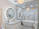 Elegant bathroom featuring marble finishes, a soaking tub, and luxury fixtures at 4966 Coquina Key Se Dr # 4966, St Petersburg, FL 33705