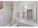 Elegant bathroom featuring white subway tiles, gold fixtures, and a shower-tub combination at 4966 Coquina Key Se Dr # 4966, St Petersburg, FL 33705