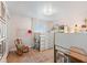 Charming bedroom with a lofted bed, a cozy desk, and a gallery wall of framed photos at 4966 Coquina Key Se Dr # 4966, St Petersburg, FL 33705