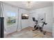 Bright bedroom with a Peloton exercise bike, decorative chandelier, and a window view at 4966 Coquina Key Se Dr # 4966, St Petersburg, FL 33705
