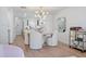 Bright dining area with a modern chandelier, seating for four, and hardwood flooring at 4966 Coquina Key Se Dr # 4966, St Petersburg, FL 33705