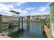 Boat docked near waterfront condos, set against a backdrop of clear waters and sunny skies at 4966 Coquina Key Se Dr # 4966, St Petersburg, FL 33705