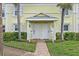 Inviting front entrance with white doors, manicured bushes, and lovely brick path at 4966 Coquina Key Se Dr # 4966, St Petersburg, FL 33705