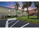 Charming two-story townhouse featuring white shutters, mature palms, and manicured landscaping at 4966 Coquina Key Se Dr # 4966, St Petersburg, FL 33705