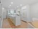 Well-lit kitchen with white cabinets, marble countertops, stainless steel appliances, and hardwood floors at 4966 Coquina Key Se Dr # 4966, St Petersburg, FL 33705
