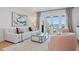 Bright living room with Gulf views through French doors, complemented by a comfortable seating arrangement at 4966 Coquina Key Se Dr # 4966, St Petersburg, FL 33705