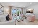 Bright and airy living room with ocean views and access to an outdoor patio at 4966 Coquina Key Se Dr # 4966, St Petersburg, FL 33705