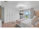 Serene bedroom with ocean views, a cozy bed, a modern chandelier, and a large closet at 4966 Coquina Key Se Dr # 4966, St Petersburg, FL 33705