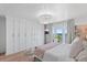 Serene bedroom with ocean view, closet, and a modern chandelier at 4966 Coquina Key Se Dr # 4966, St Petersburg, FL 33705