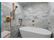 Detailed view of the luxurious marble shower, with brass fixtures and a rainfall showerhead at 4966 Coquina Key Se Dr # 4966, St Petersburg, FL 33705