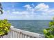 Water view from a patio featuring lush greenery, blue skies, and puffy white clouds at 4966 Coquina Key Se Dr # 4966, St Petersburg, FL 33705