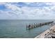 Beautiful water view featuring a wooden pier extending into the ocean on a sunny day at 4966 Coquina Key Se Dr # 4966, St Petersburg, FL 33705