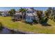 Waterfront home with screened in pool, tropical landscaping, and private dock access at 5321 Fishersound Ln, Apollo Beach, FL 33572