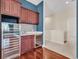 This bar area includes dark wood cabinets, granite countertops, stainless beverage refrigerator and wine cooler at 5321 Fishersound Ln, Apollo Beach, FL 33572