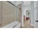 The bathroom has a tiled shower with a sliding glass door and a view into the next room at 5321 Fishersound Ln, Apollo Beach, FL 33572