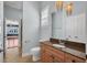 Bathroom with granite counters, single sink vanity with cabinets and a decorative light fixture at 5321 Fishersound Ln, Apollo Beach, FL 33572