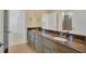 Bathroom featuring granite counters, double sinks, vanity with cabinets and a large mirror at 5321 Fishersound Ln, Apollo Beach, FL 33572
