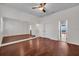 This bright bedroom features hardwood floors, a large mirror, and a doorway leading to another room at 5321 Fishersound Ln, Apollo Beach, FL 33572