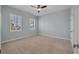 Bedroom features neutral carpet, blue walls, two windows with shutters, and ceiling fan at 5321 Fishersound Ln, Apollo Beach, FL 33572