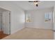 Neutral bedroom featuring carpet, white walls, two windows with shutters, and a ceiling fan at 5321 Fishersound Ln, Apollo Beach, FL 33572