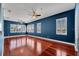 Spacious bonus room featuring rich dark wood floors and a wall of large windows at 5321 Fishersound Ln, Apollo Beach, FL 33572