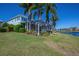 Charming home exterior with screened lanai, lush landscaping, and waterfront access at 5321 Fishersound Ln, Apollo Beach, FL 33572