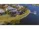 Waterfront home featuring a screened-in pool, private dock and lush tropical landscaping at 5321 Fishersound Ln, Apollo Beach, FL 33572