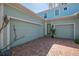 Attached two-car garage with brick driveway and appealing architectural details at 5321 Fishersound Ln, Apollo Beach, FL 33572