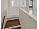 View of hallway and stairs with carpeted steps and a white banister at 5321 Fishersound Ln, Apollo Beach, FL 33572