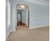 Hallway with carpet floor and view to another room with wood floor and chandelier lighting at 5321 Fishersound Ln, Apollo Beach, FL 33572