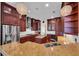 Spacious kitchen boasts granite counters, cherry cabinets, and stainless appliances at 5321 Fishersound Ln, Apollo Beach, FL 33572