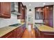 Kitchen with wood cabinets, granite countertops, mosaic backsplash, and stainless steel appliances at 5321 Fishersound Ln, Apollo Beach, FL 33572