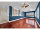 A spacious living room is enhanced with a hardwood floor, plantation shutters and ceiling fans at 5321 Fishersound Ln, Apollo Beach, FL 33572