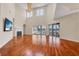 Spacious living room with hardwood floors, fireplace, high ceilings, and access to outdoor living space at 5321 Fishersound Ln, Apollo Beach, FL 33572