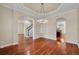 Open-concept living room featuring a decorative chandelier and access to kitchen at 5321 Fishersound Ln, Apollo Beach, FL 33572