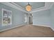 Inviting main bedroom with modern ceiling light, plantation shutters, and doorway to another room at 5321 Fishersound Ln, Apollo Beach, FL 33572