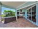 Outdoor kitchen with a stainless grill, refrigerator, sink, counter seating, and a hot tub to the side at 5321 Fishersound Ln, Apollo Beach, FL 33572